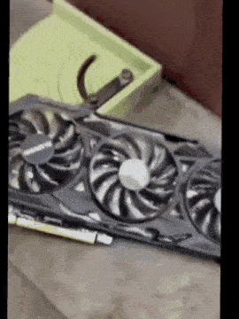 a computer graphics card is sitting on a table next to a pair of scissors .