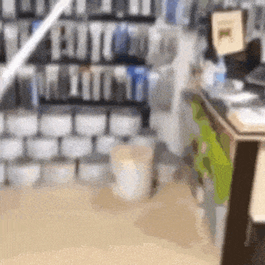a blurred image of a store with a lot of boxes on the shelves