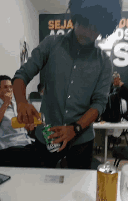 a man is opening a can of mc donald 's in front of a sign that says seja