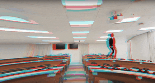 a blurry picture of a classroom with a man standing in the middle