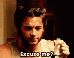 a man with a beard is holding a bottle and saying excuse me .
