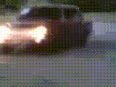 a blurry picture of a car with flames coming out of its exhaust pipes