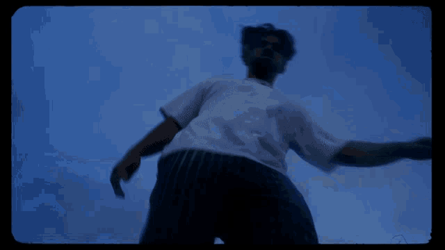 a blurry picture of a person in a white shirt and black pants