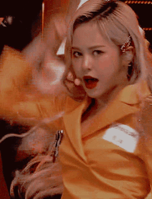 a woman wearing a yellow jacket with a name tag that says ea
