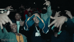 a group of people with their hands in the air including one wearing a shirt that says ' mafia ' on it