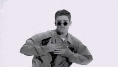 a black and white photo of a man wearing sunglasses and a jacket .