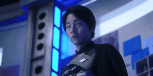 a man with his eyes closed in a room with blue lights .