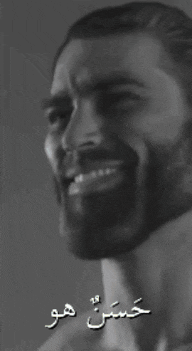 a black and white photo of a man with arabic writing