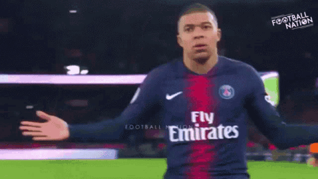 a soccer player in a fly emirates jersey