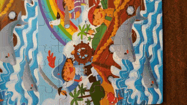a puzzle with a picture of dolphins and a pirate on it