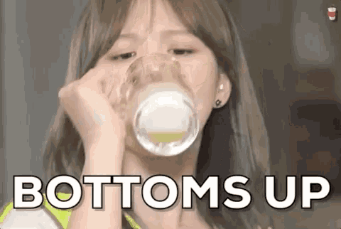 a woman is drinking a glass of milk with the words `` bottoms up '' written on the bottom .