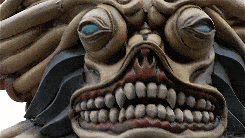 a close up of a monster 's face with teeth