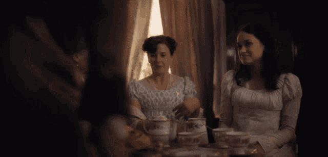 two women sit at a table with the words " you see we were sure of a good fire " above them