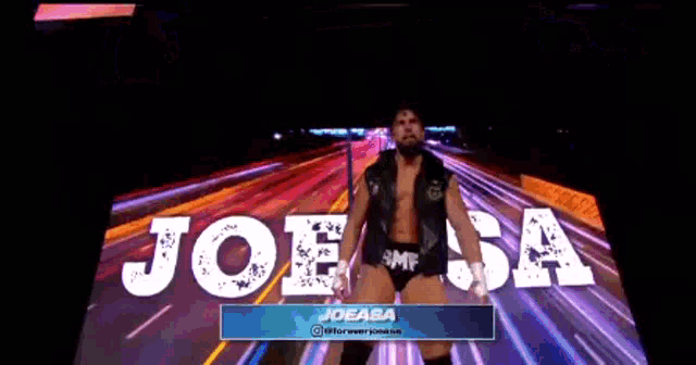 a man is standing in front of a screen that says joesa on it