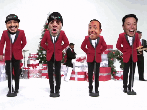 a group of men in red suits are singing into microphones