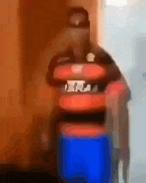 a blurry picture of a man carrying a blue cooler and a red cooler .