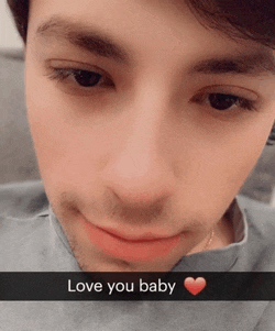 a close up of a man 's face with the words love you baby written on it