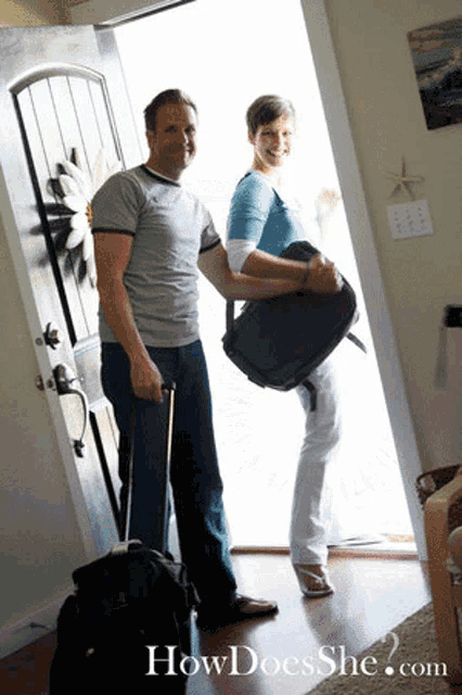 a man and woman standing in front of a door with howdoesshe.com on the bottom right