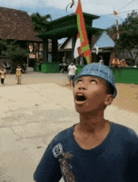 a boy wearing a blue hat and a blue shirt with the letter e on it