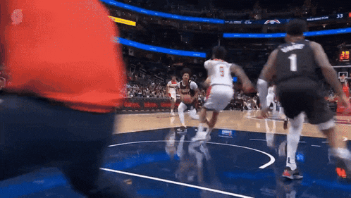 a basketball player with the number 1 on his jersey is dribbling the ball