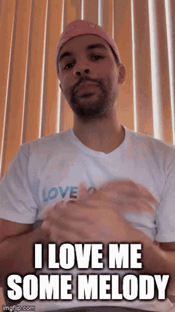a man wearing a white shirt that says love on it