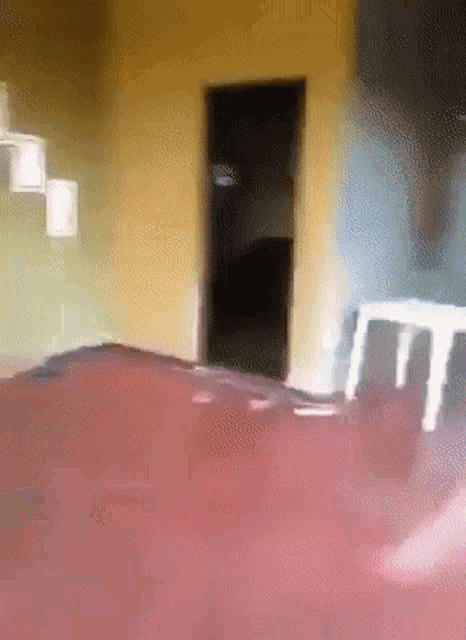 a blurry picture of a room with stairs and a doorway
