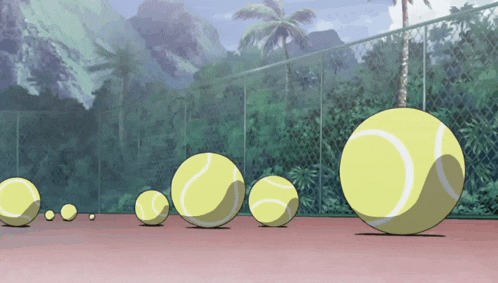 a bunch of tennis balls are on a court