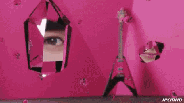 a woman in a cat costume is laying on a pink carpet