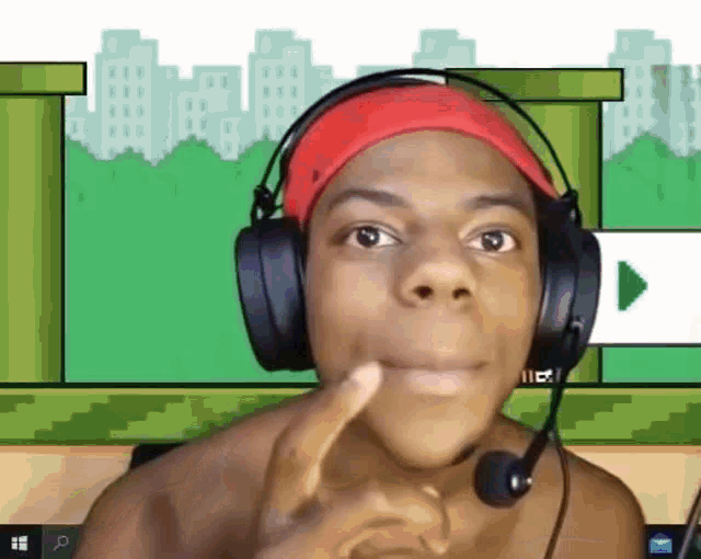 a man wearing headphones and a red hat is making a face .
