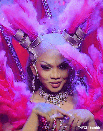 a close up of a woman wearing a costume with feathers and rhinestones ..