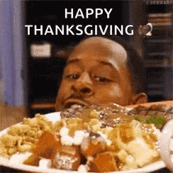 a man is eating a plate of food with the words `` happy thanksgiving '' written above him .