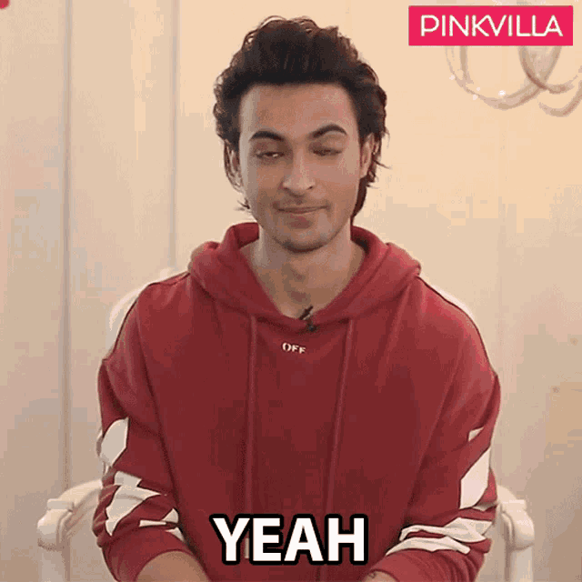 a man in a red hoodie says yeah