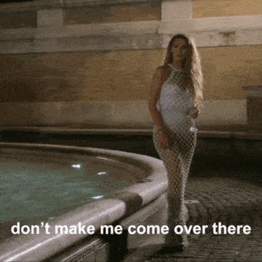 a woman in a white dress stands in front of a fountain with the words " don t make me come over there "