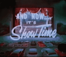 a drive in theater with a sign that says and now it 's showtime