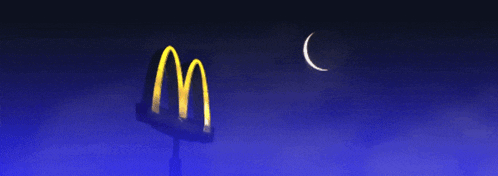 a mcdonald 's sign is lit up in the dark