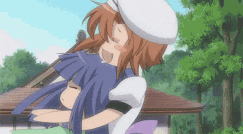 a girl in a white hat is hugging another girl in a blue dress .