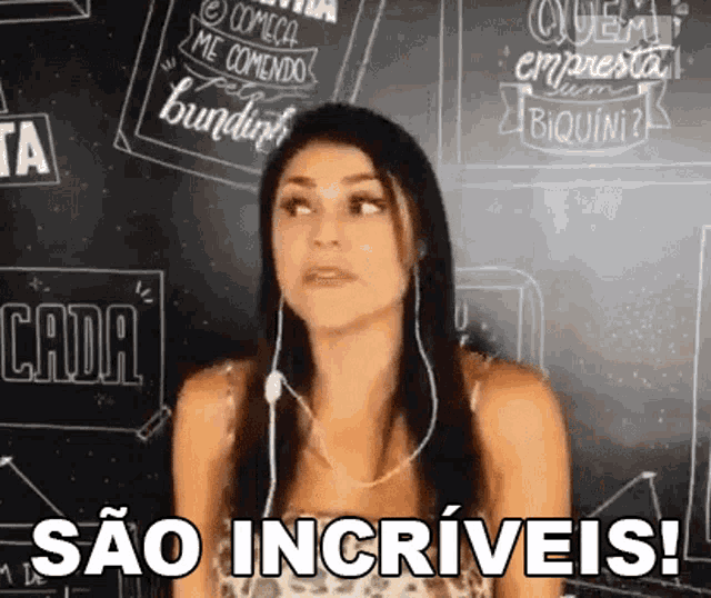 a woman wearing headphones is standing in front of a blackboard and says sao incrivels !