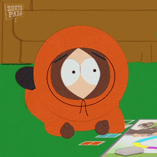 a cartoon character from south park sits on a table