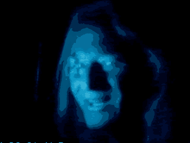 a close up of a person 's face with a dark background and a blue glow