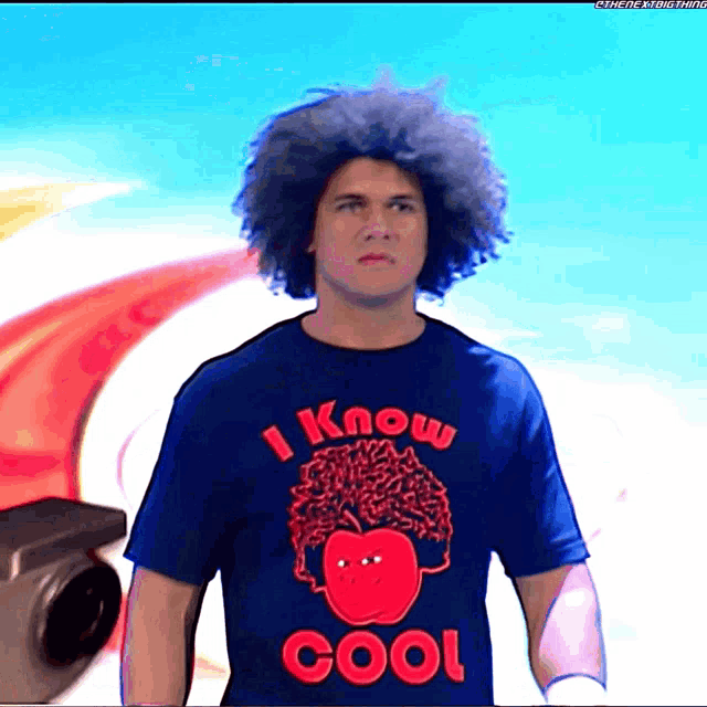 a man with curly hair is wearing a blue shirt that says i know cool