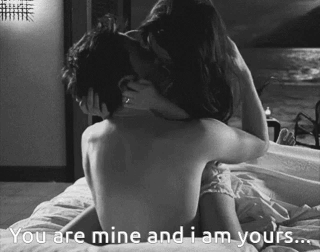 a black and white photo of a man and a woman kissing with the caption " you are mine and i am yours "