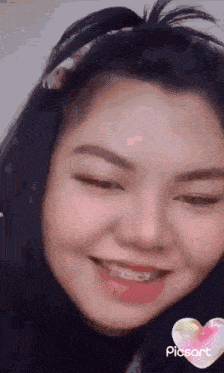 a close up of a woman 's face with braces on her teeth