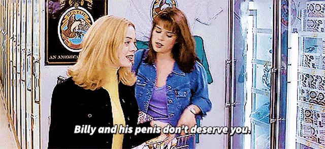 two women are standing next to each other in a store and one says billy and his penis don 't deserve you