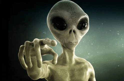 a grey alien pointing at the camera with his finger