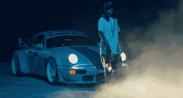 a man stands in front of a rauh-woll porsche