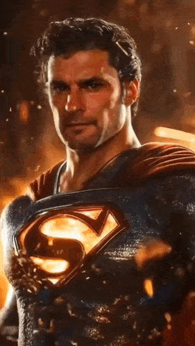 a close up of a man in a superman costume with a s on his chest .