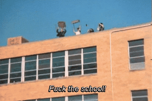 a group of people on the roof of a building with the words fuck the school