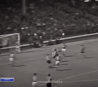 a black and white photo of a soccer game with a goalie wearing number 6