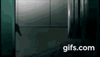 a person is standing in an elevator with a gifs.com logo in the corner