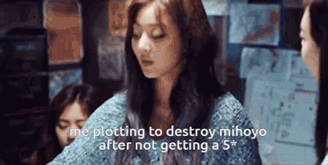 a woman in a blue sweater is sitting in a room with other women and talking .